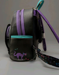 Loungefly mini backpack side view with purple and teal accents featuring a spooky black cat illustration on black faux leather