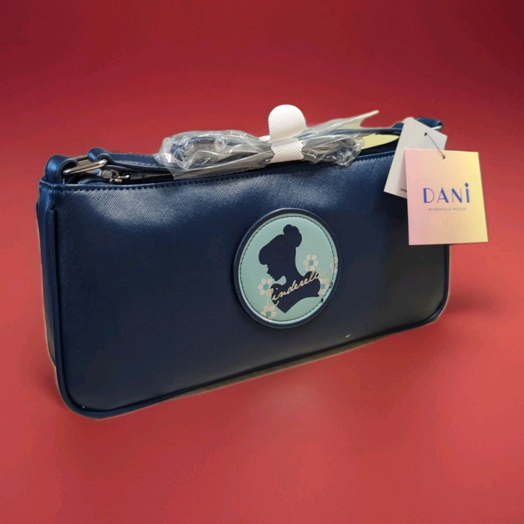 Danielle navy baguette bag with Cinderella silhouette patch and floral details on front in protective wrapping