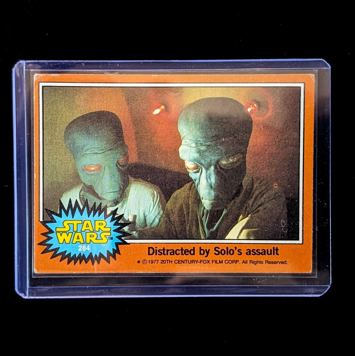 1977 Topps Star Wars trading card featuring Greedo titled Distracted by Solo’s assault by Go Figment