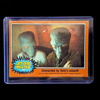 1977 Topps Star Wars trading card featuring Greedo titled Distracted by Solo’s assault by Go Figment