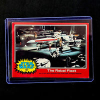 1977 Go Figment Star Wars trading card featuring The Rebel Fleet from the Red Series 2 collection in protective case