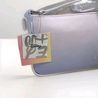 Danielle Nicole pastel gradient baguette bag with Disney logo tag and soft textured faux leather close-up view