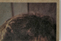 Close-up of vintage book page showing textured print and faded brownish background tones