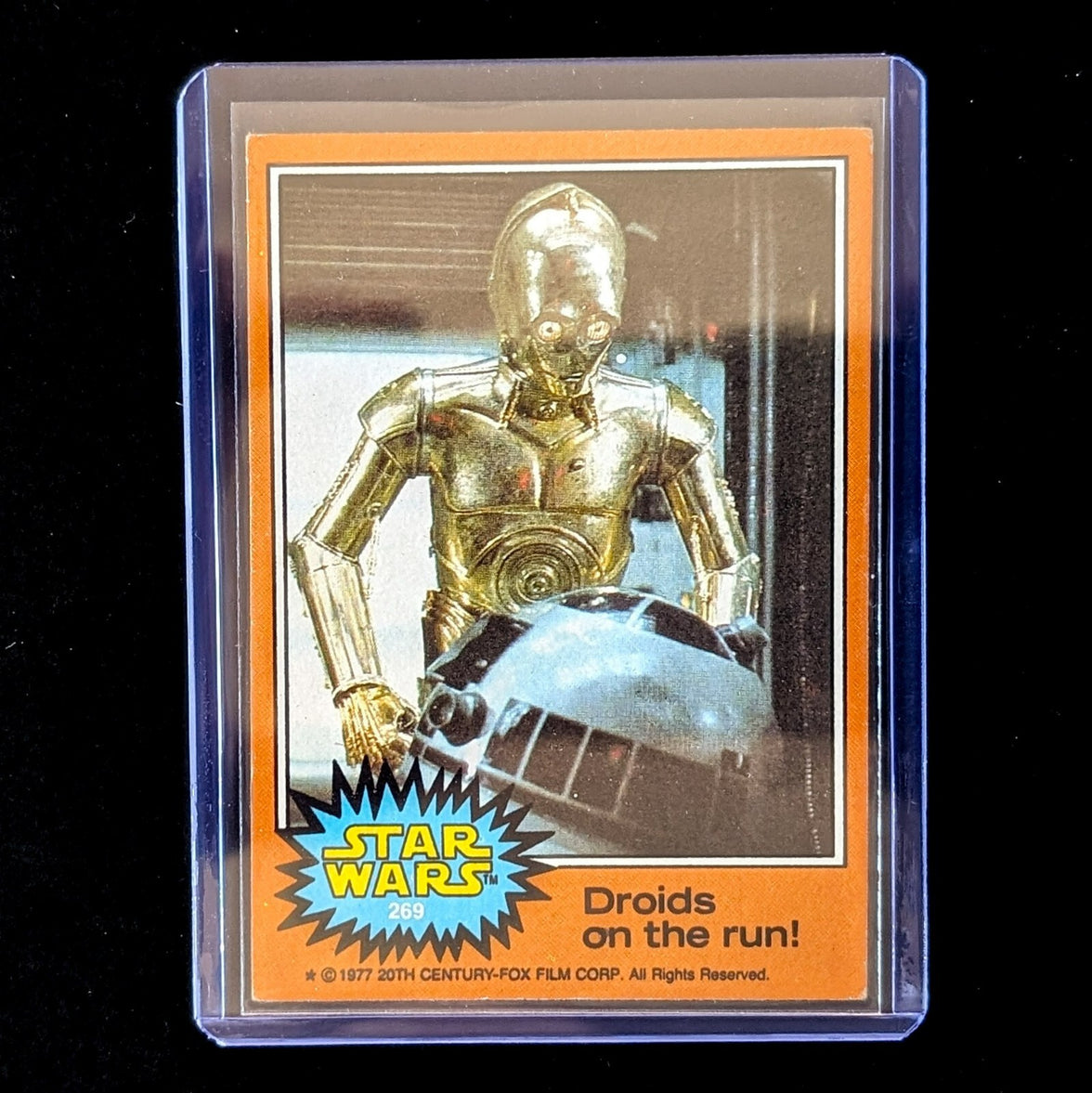 1977 Topps Star Wars orange Series 4 trading card featuring C-3PO and R2-D2 by Go Figment