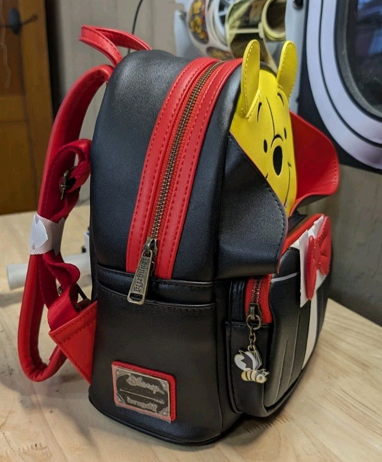 Loungefly mini backpack showing Winnie the Pooh vampire design with red accents and bee charm on front zipper pocket