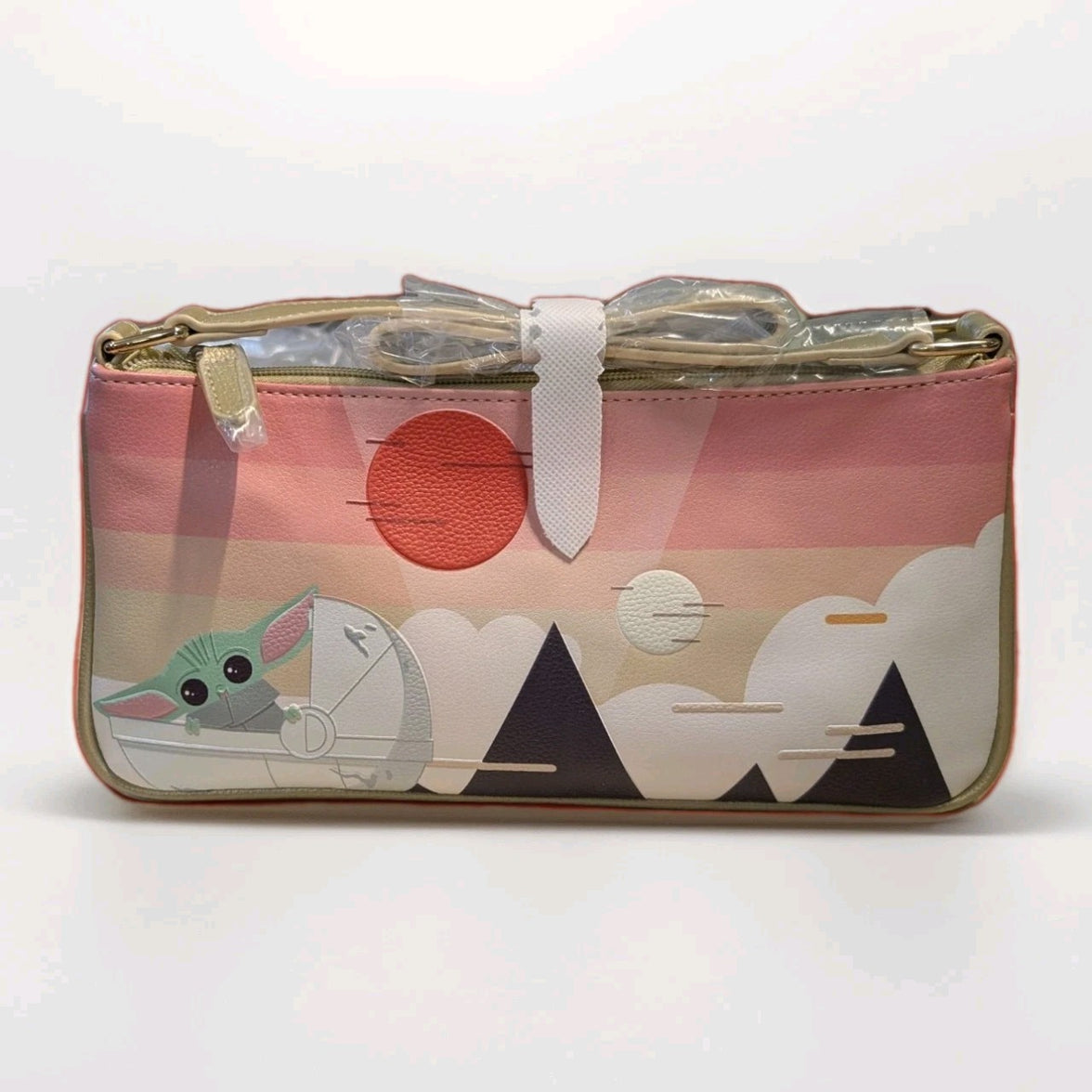 Danielle Nicole crossbody bag with Grogu holding a bow against stylized mountains and a red sun background