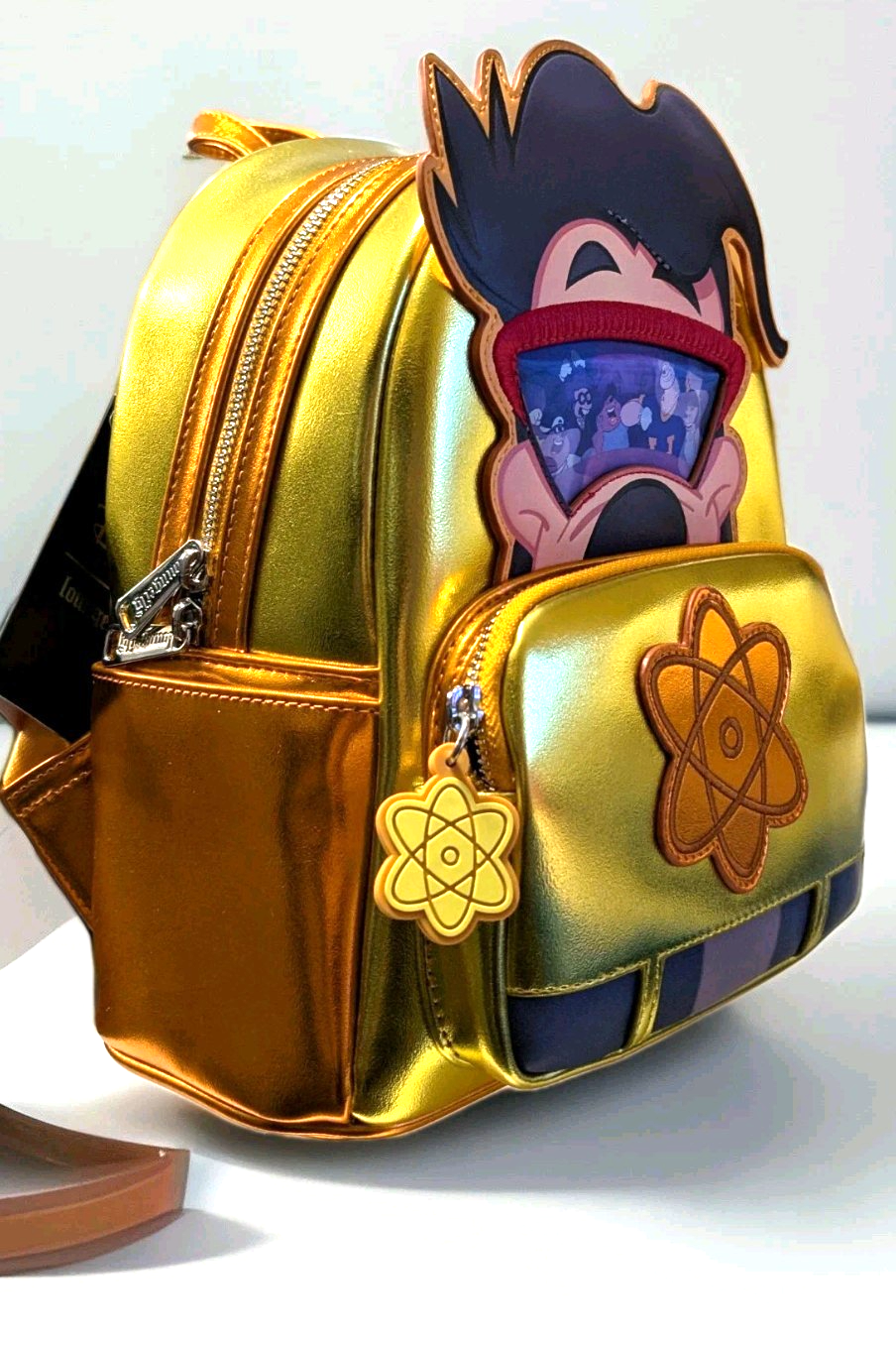 Loungefly mini backpack in metallic gold featuring Max Powerline character with atomic symbol on front pocket zipper charm