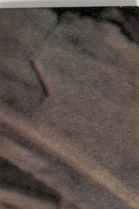 Close-up of textured dark fabric background for Go Figment vintage collectible display setup