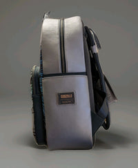 Loungefly full-size backpack side view in metallic silver with Godzilla logo patch and padded black straps visible
