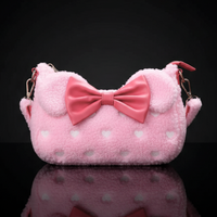 Loungefly pink sherpa crossbody bag with strawberry scent, heart patterns, oversized bow, and ears detail against black background