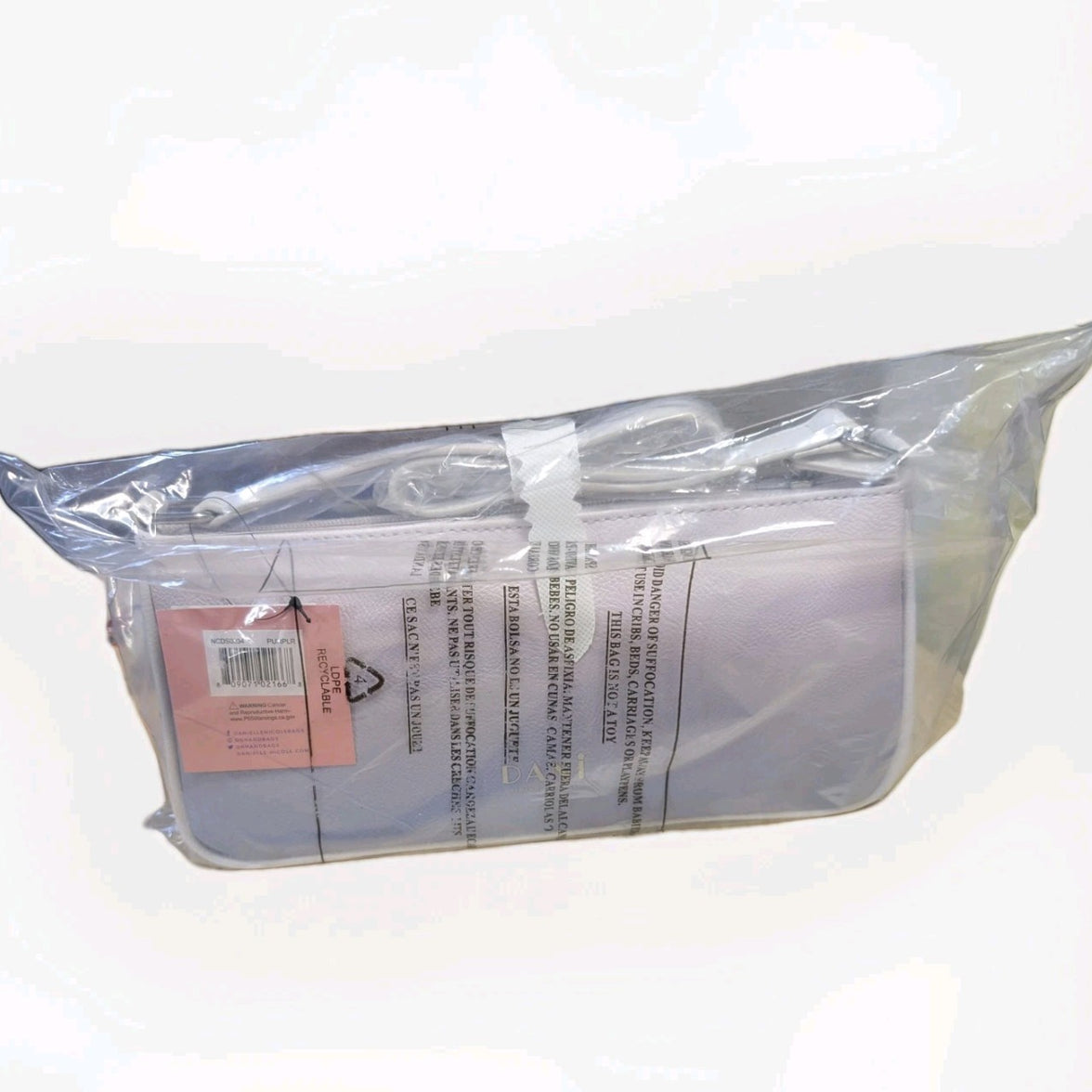 Danielle Nicole Ariel Little Mermaid crossbody bag in clear plastic packaging with barcode and care instructions visible