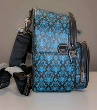 Loungefly Disney Haunted Mansion backpack side view showing blue damask pattern and Tomb Sweet Tomb zipper pull