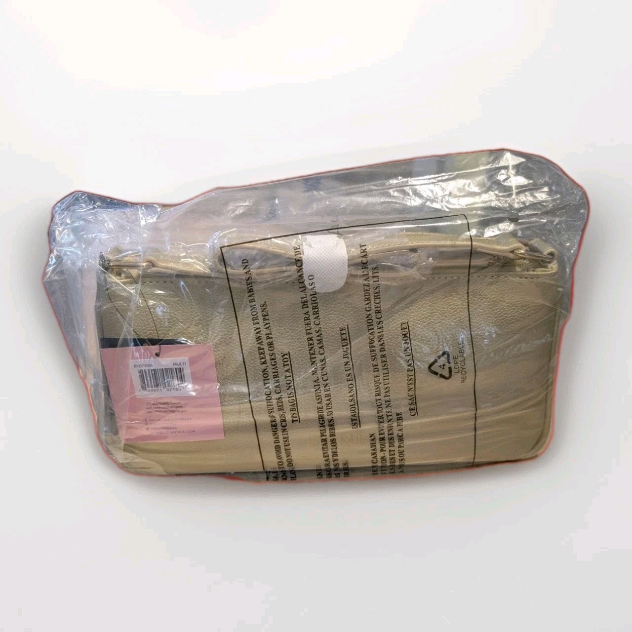 Danielle Nicole crossbody bag featuring beige textured leather in clear protective packaging with barcode and warning label visible