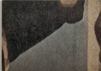 Close-up of textured fabric showing dark and light color contrast with visible fibers and stitching details