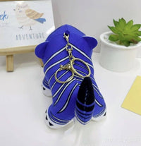 K-Wonderland plush tiger keyring in rich blue with white stripes and gold clasp displayed on white surface with decor background