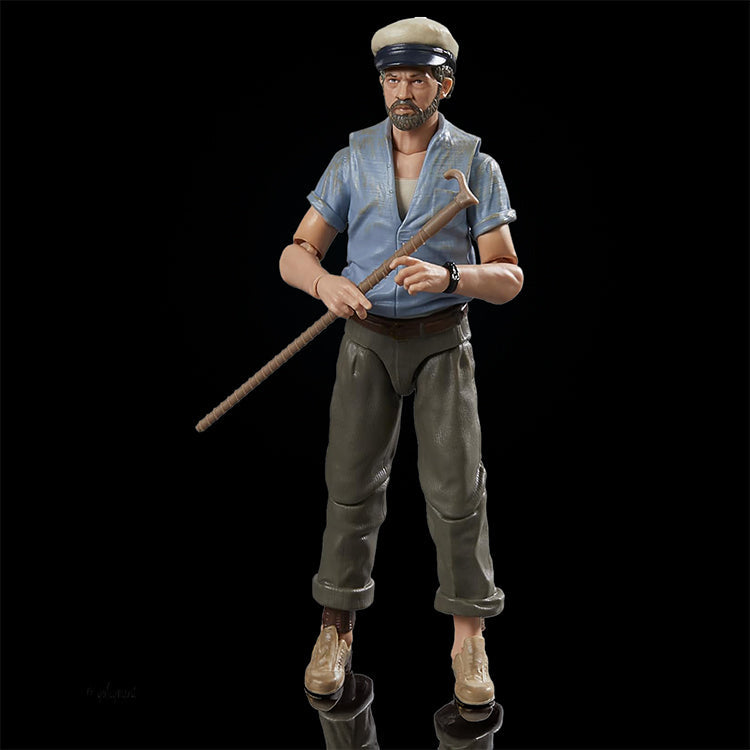 Hasbro Indiana Jones action figure wearing blue shirt and cap holding long staff against black background