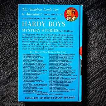 Vintage Hardy Boys book The Twisted Claw 1969 edition with distinctive blue cover and red accents by Grosset & Dunlap