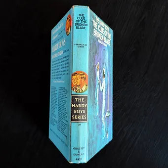Vintage hardcover edition of The Clue of the Broken Blade, Hardy Boys Book 21 by Franklin W. Dixon published by Grosset & Dunlap