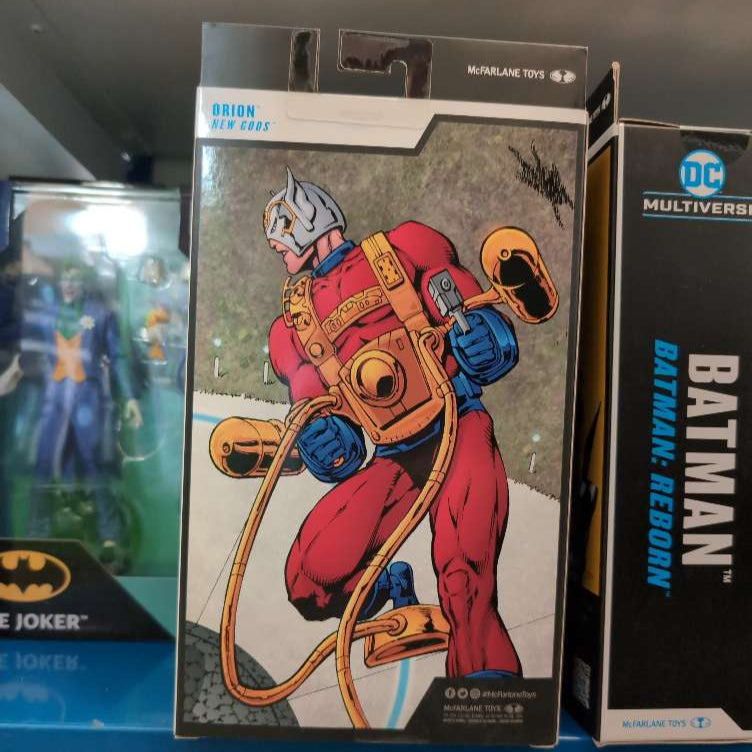 McFarlane DC Multiverse Orion New Gods action figure box side with comic art in collectible display with Batman and Joker figures