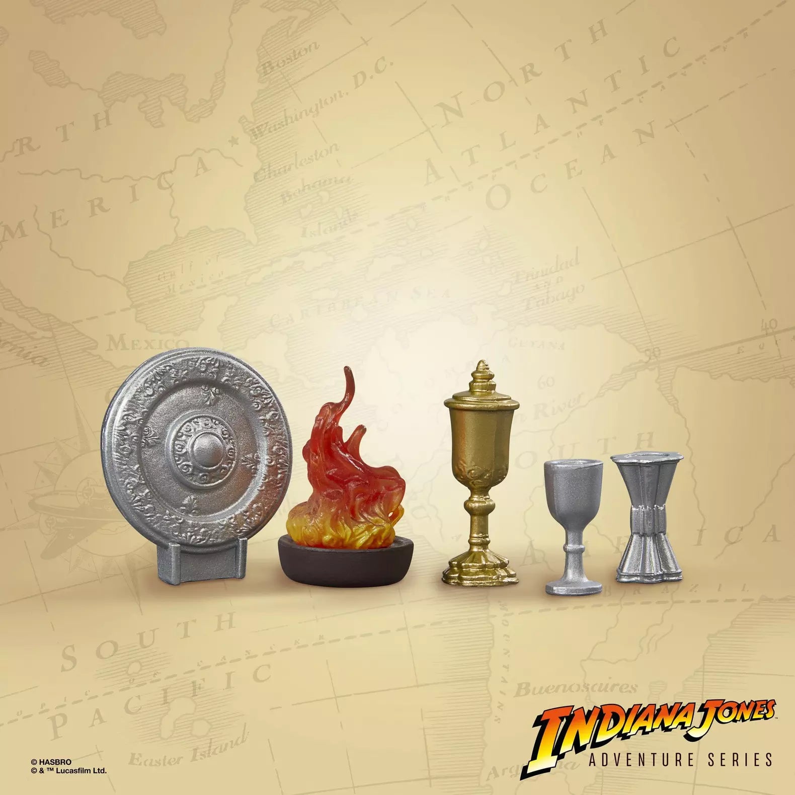 Five detailed Indiana Jones Holy Grail table artifact pieces from Hasbro set against vintage map background