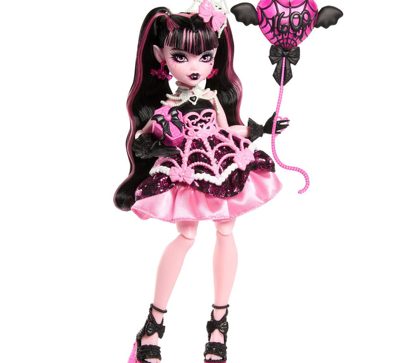 Mattel Monster High Draculaura doll in pink and black birthday dress holding bat-shaped balloon accessory