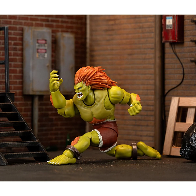 Jada Toys Ultra Street Fighter II Blanka 6-inch deluxe action figure posed in urban alley scene with brick walls and stairs