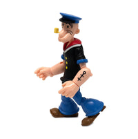 Boss Fight Studio Llc Popeye figure in black shirt, blue pants, sailor hat, pipe walking pose side view