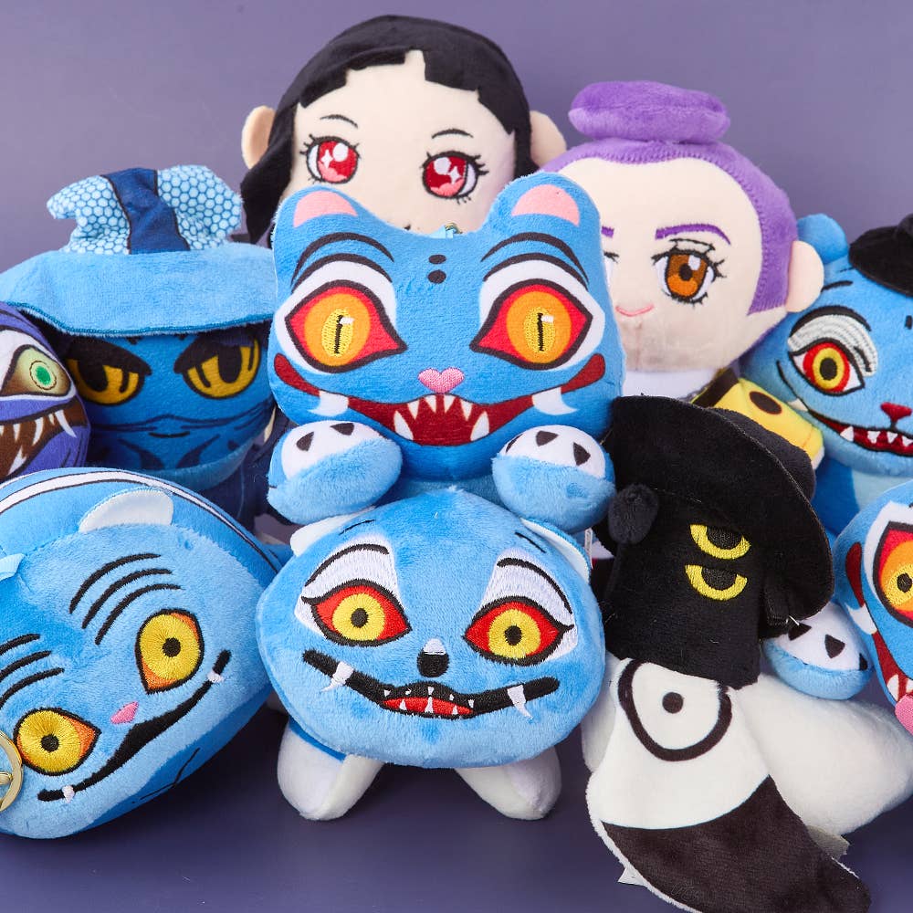 K-Wonderland K-Pop Hunters collection showing plush tiger keyrings and character figures with colorful embroidered faces on purple background