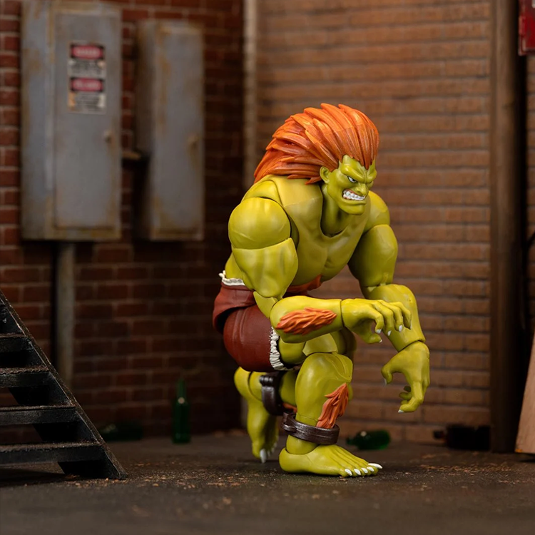 Jada Toys Ultra Street Fighter II Blanka 6-inch deluxe action figure crouching with orange hair in urban alley background