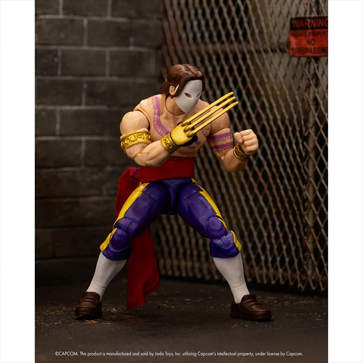 Jada Toys Ultra Street Fighter II Vega 6-inch poseable action figure with mask and claw accessories displayed in urban setting