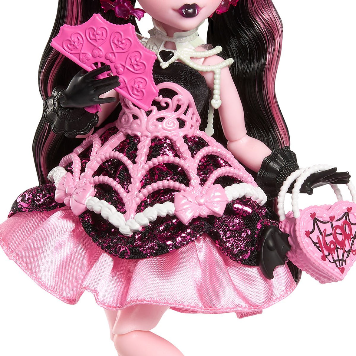 Monster High Draculaura doll in pink black spiderweb dress holding heart-shaped purse and fan by Mattel