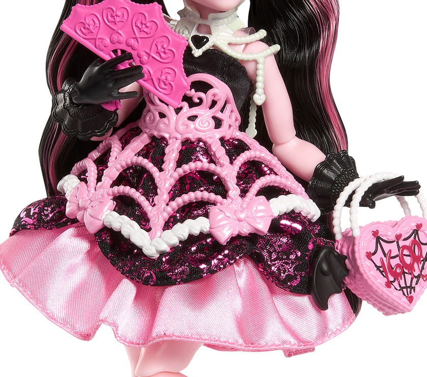 Monster High Draculaura doll in pink black spiderweb dress holding heart-shaped purse and fan by Mattel