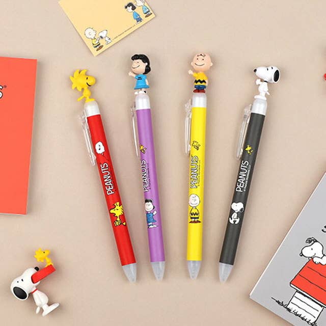 K-Wonderland Peanuts ballpoint pens in red, purple, yellow, and gray with Snoopy and Friends character toppers