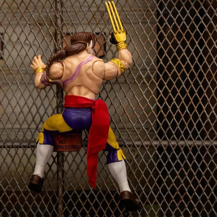 Jada Toys Ultra Street Fighter II Vega 6-inch action figure posed climbing a chain-link fence with red sash and claw gloves