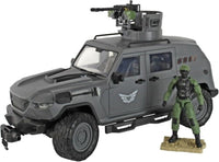 Gray armored military vehicle with roof turret beside a green action figure on a display base