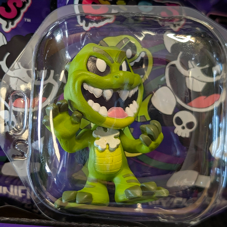 Go Figment Nightmare Critters Series 4 green dinosaur-like mini figure with sharp teeth in clear blister packaging