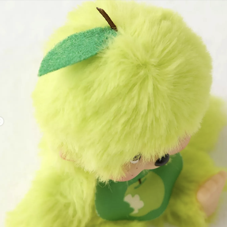 Sekiguchi Monchhichi plush in vibrant apple green with soft fur and detailed leaf accessory on head.