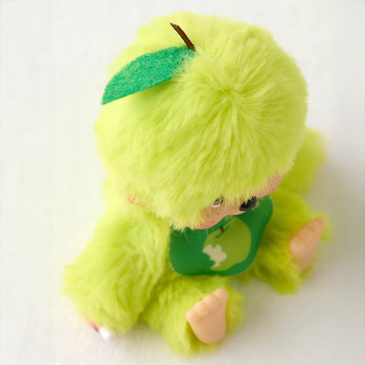 Sekiguchi Monchhichi plush in apple green with soft fur and fruity bib, perfect collectible or gift companion.