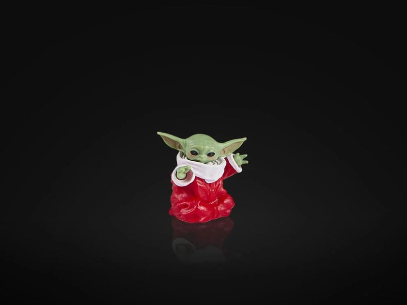 Hasbro Star Wars Black Series Baby Yoda figure in red holiday outfit on black background