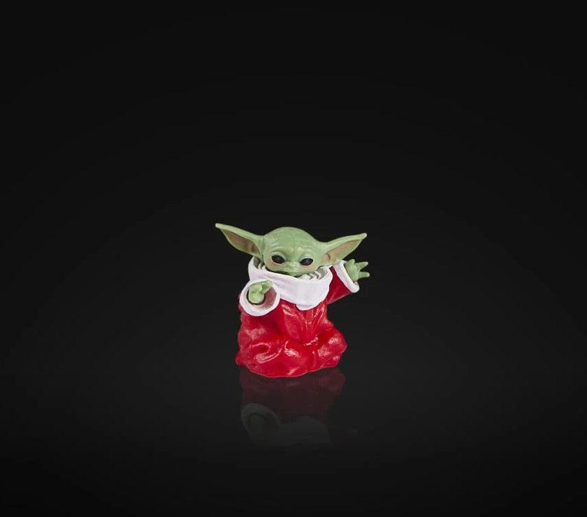 Hasbro Star Wars Black Series Baby Yoda figure in red holiday outfit on black background