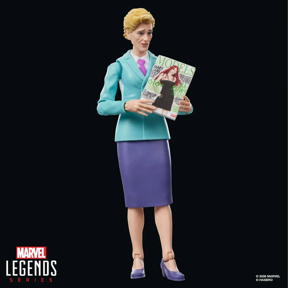 Marvel Legends Series female character figure in a teal suit holding a fashion magazine against a black background
