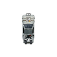 Front view of a gray futuristic toy vehicle with a windshield, top hatch, and front wheels