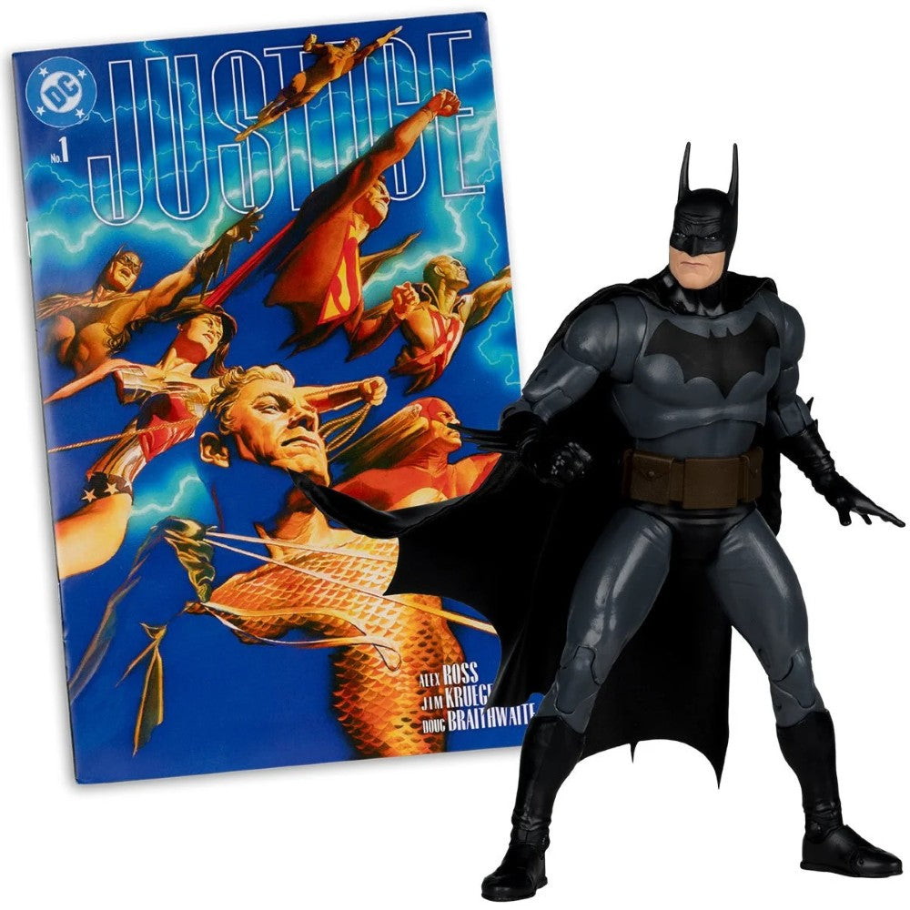 Batman action figure posed beside a Justice comic book cover featuring multiple superheroes in dynamic poses.