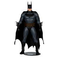 Batman action figure in black and gray suit with cape and bat emblem standing on a display base