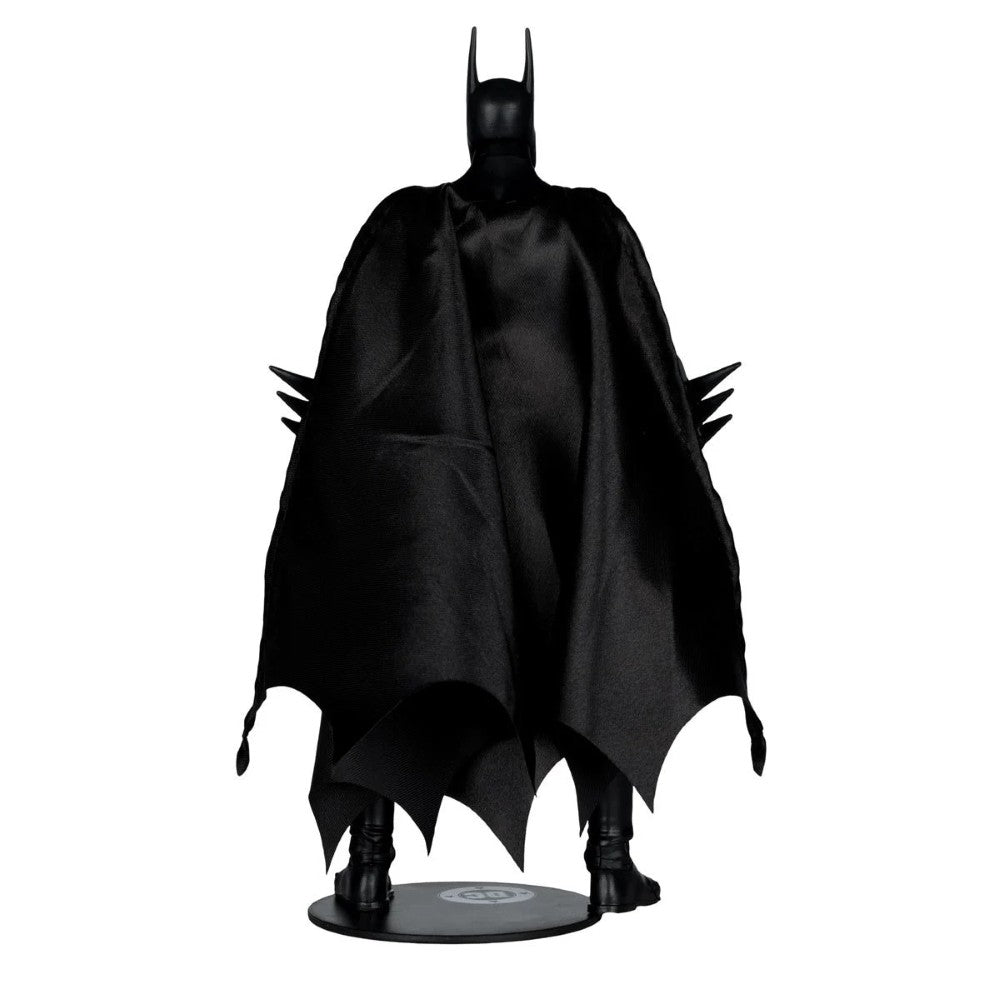 Action figure standing with a flowing black cape and pointed bat ears, holding spiked gauntlets on each arm.