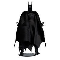 Action figure standing with a flowing black cape and pointed bat ears, holding spiked gauntlets on each arm.