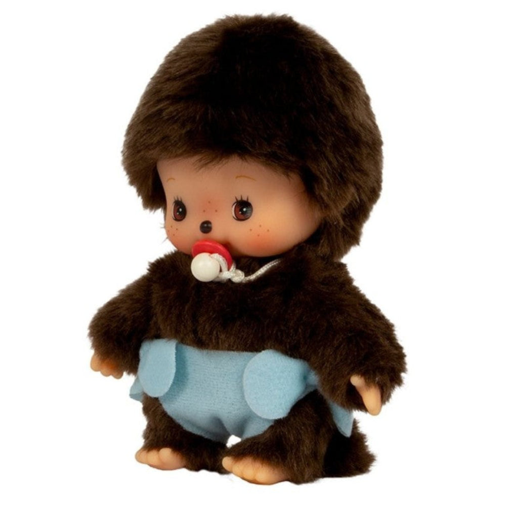A small Choupette-style plush toy with dark brown faux fur, a peach-toned face, a red-and-white pacifier, and a light blue diaper, photographed on a plain white background.