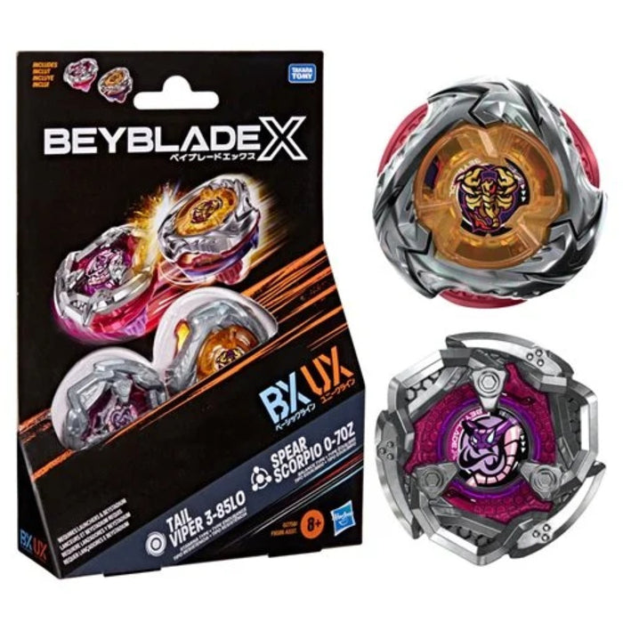 Beyblade X package beside two colorful spinning tops in silver, red, orange, and purple