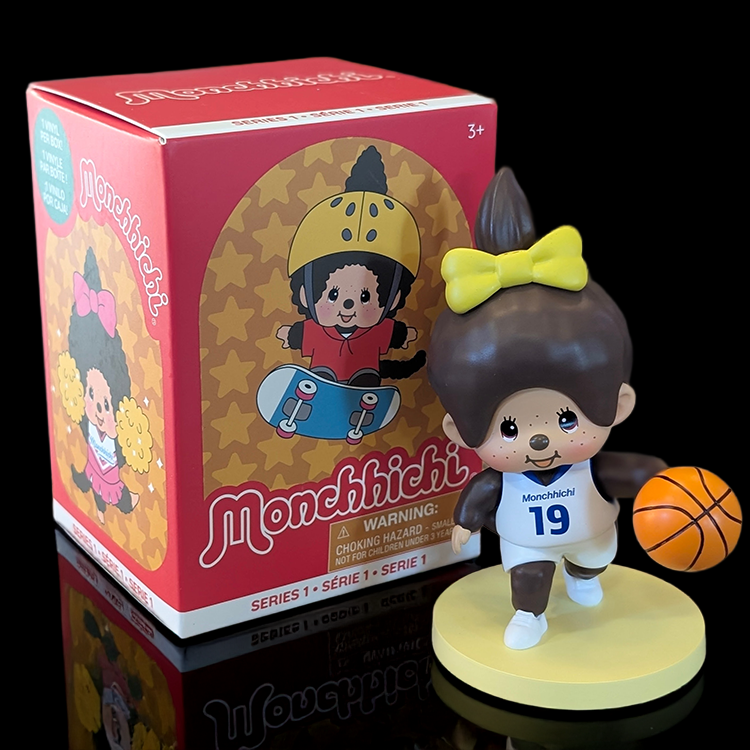 Sekiguchi Girl Monchhichi basketball player vinyl figure with yellow bow and basketball on display stand.