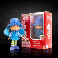 Blueberry Muffin Strawberry Shortcake doll with blue hair and outfit displayed next to red Loyal Subjects packaging.